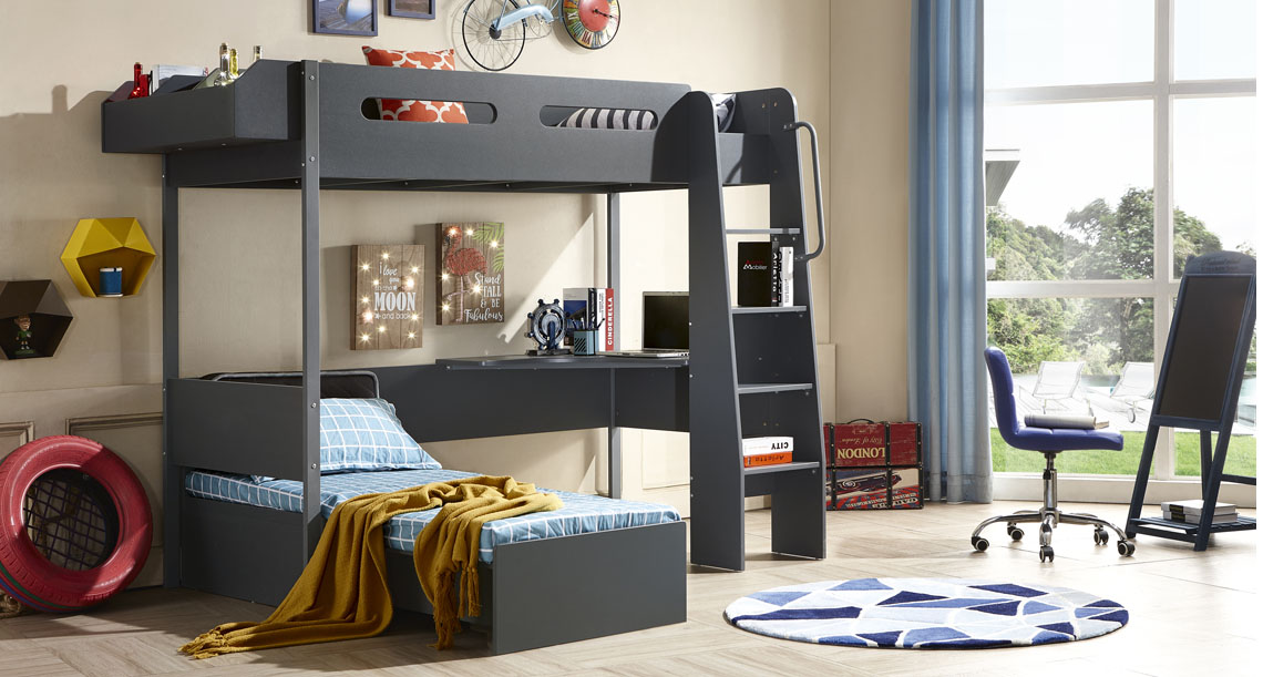 Colourful kids room with large dark grey bunk bed with top and bottom beds connected by ladder and a small desk next to bottom bed and small shelf on side of top bed